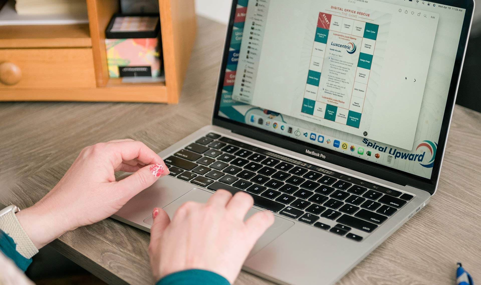 Hands typing on a keyboard with the Digital Office Rescue game board on the screen