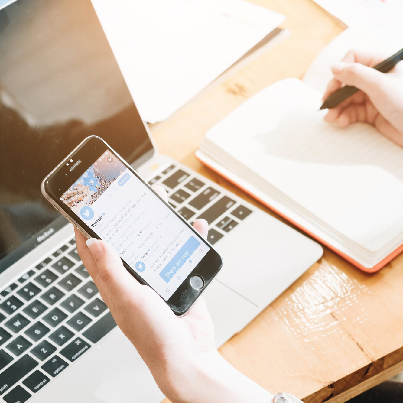 CHIANG MAI,THAILAND - June 7,2018 : Female Copywriting write article form twitter news in mobile phone.